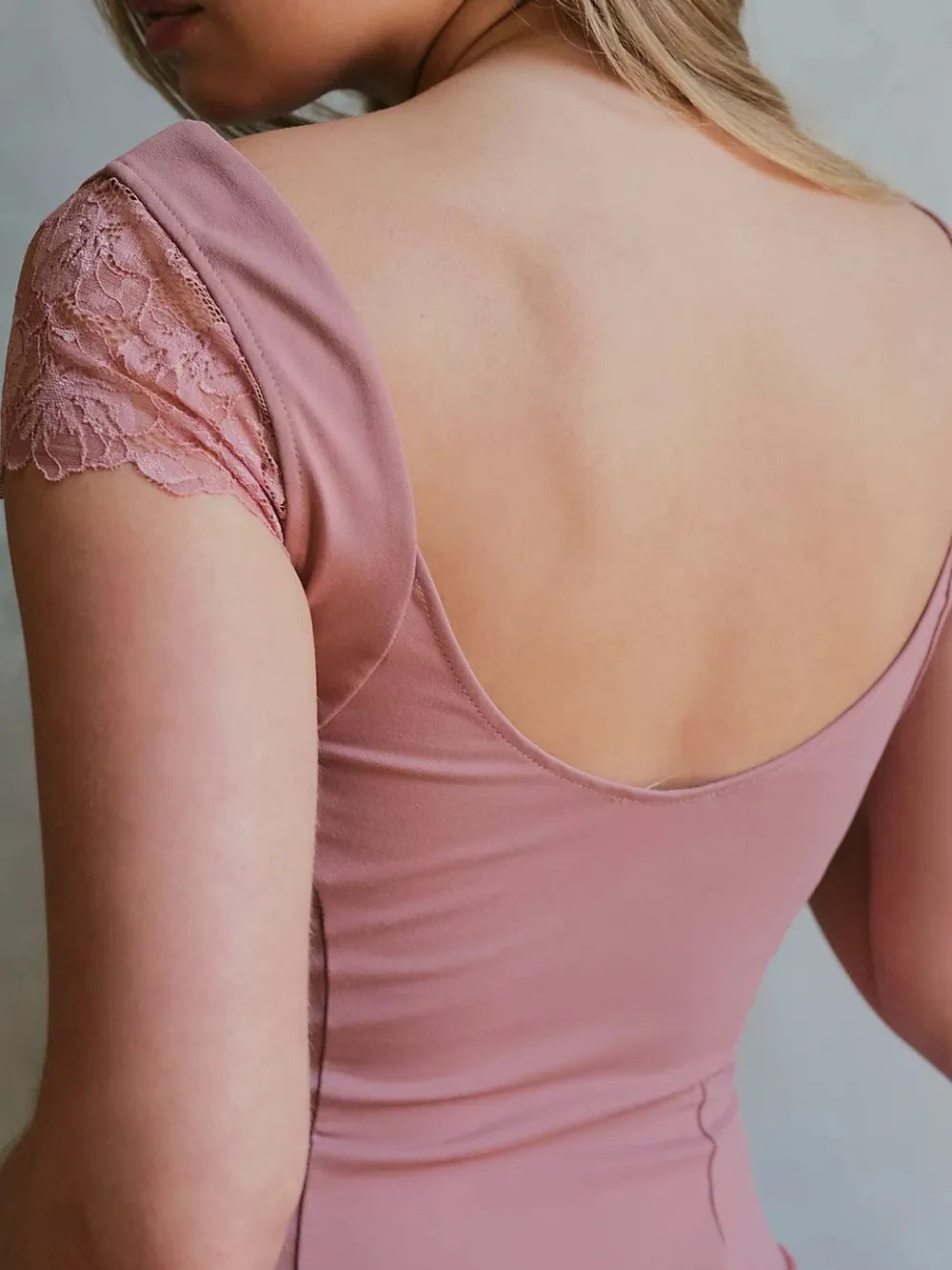 Back view of woman wearing a Pink Lace Detail V-Neck Cap Sleeve Top on a plain background
