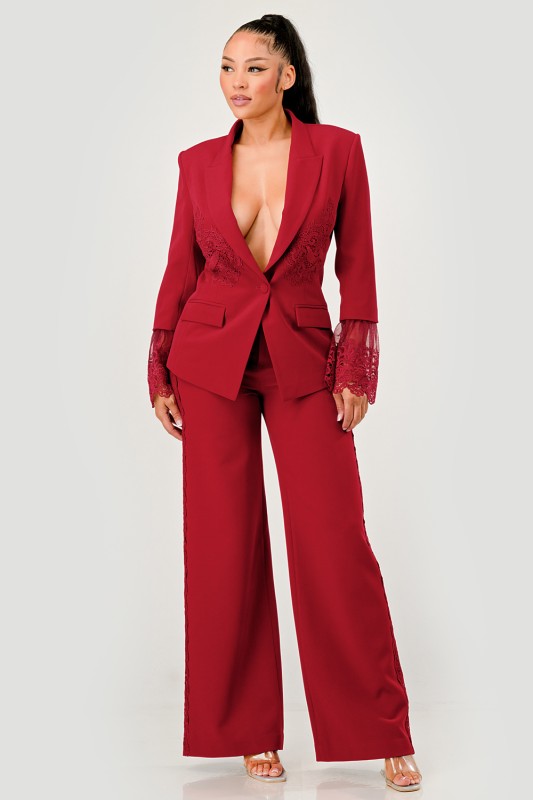 front view of woman wearing a red/burgundy high-fashion tailored suit with lace detailing for evening events
