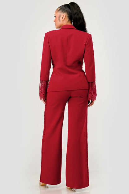 back view of woman wearing a red/burgundy high-fashion tailored pant suit for evening events