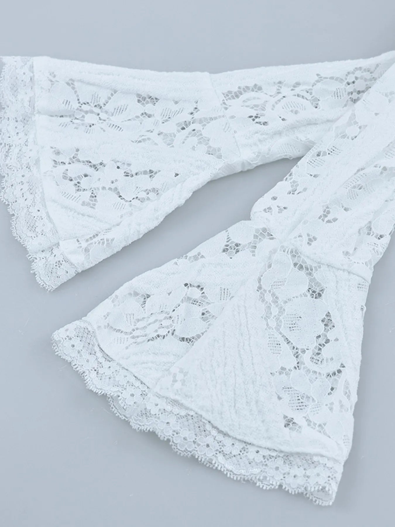 close up of flounce sleeve for White Lace Off-Shoulder Maxi Dress on a gray background