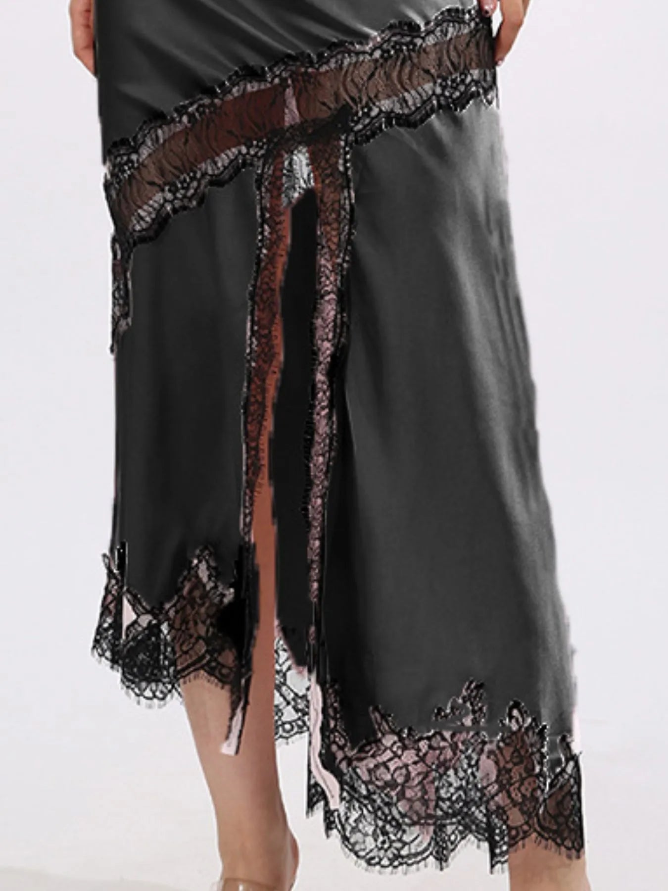 Black satin midi skirt with lace trim and thigh high front slit on a white background