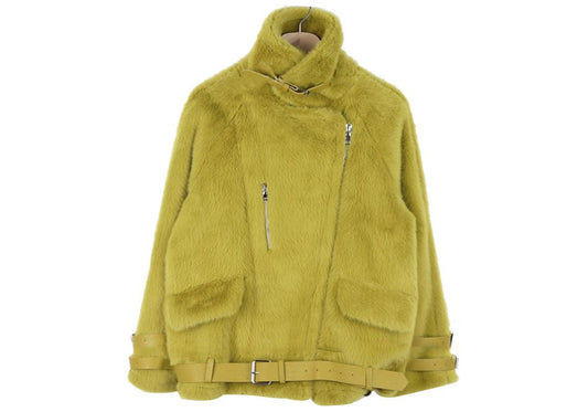 A green faux fur coat with a stand-up collar and leather buckles on a hanger on a white background