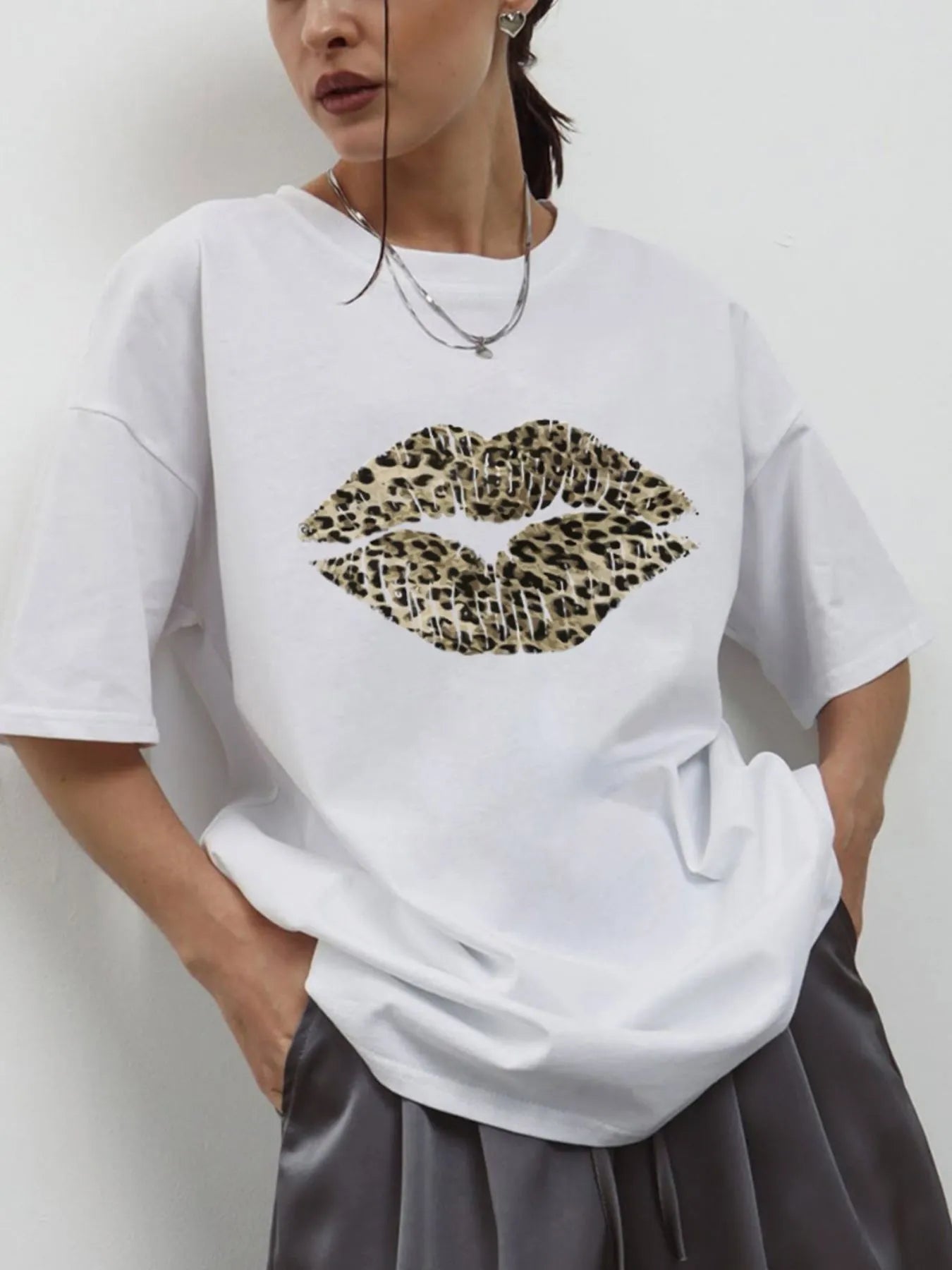 Model wearing oversized  leopard lip graphic and round neckline graphic tee with relaxed fit