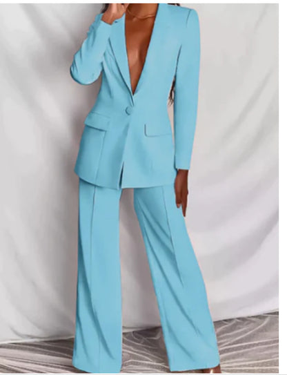Woman modeling a light blue elegant long sleeve blazer and matching trousers suit set.

