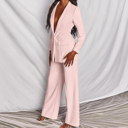 Woman modeling a light pink elegant long sleeve blazer and matching trousers suit set.

