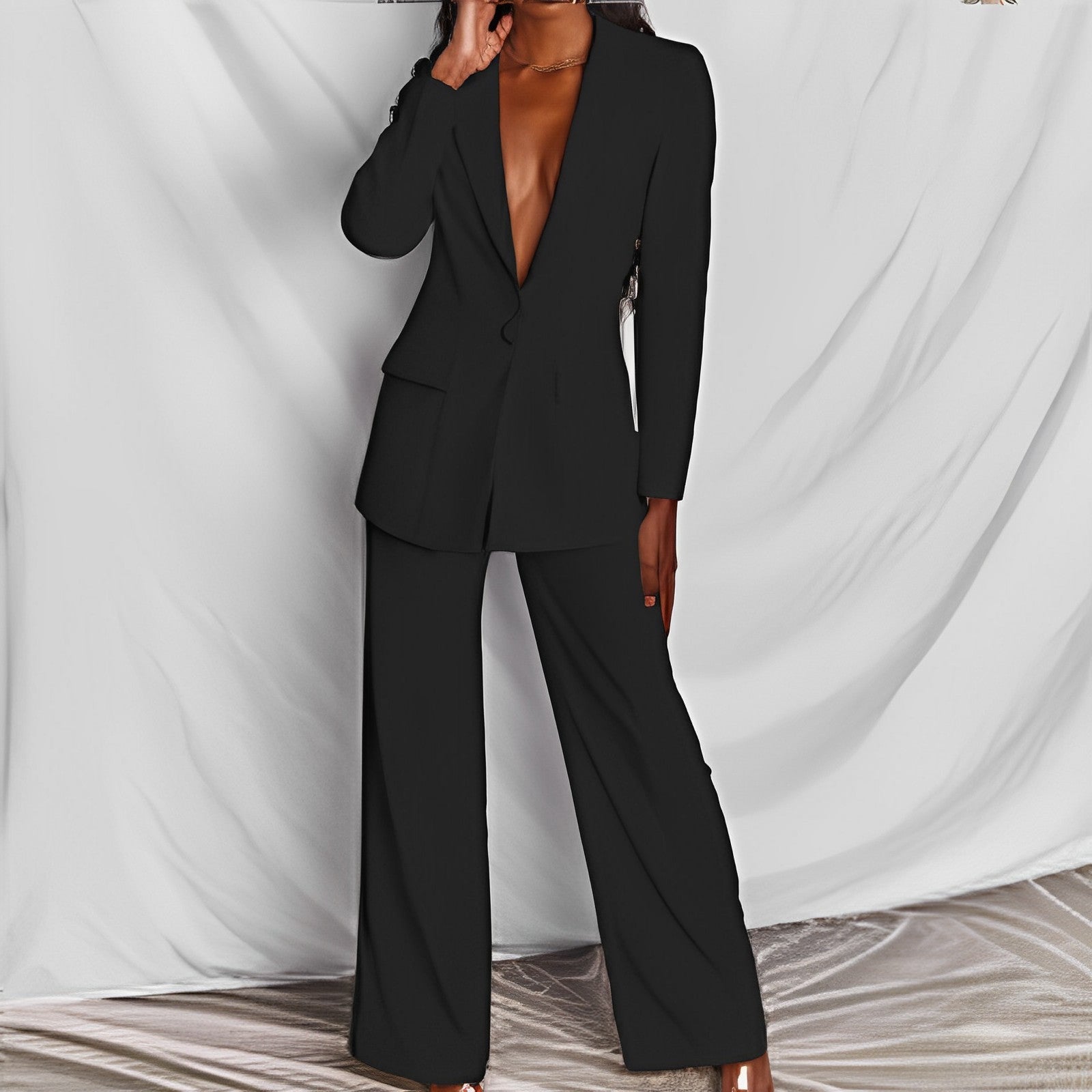 Woman modeling a black elegant long sleeve blazer and matching trousers suit set for office wear.

