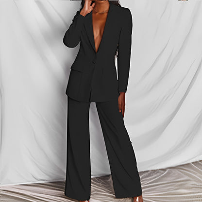 Woman modeling a black elegant long sleeve blazer and matching trousers suit set for office wear.

