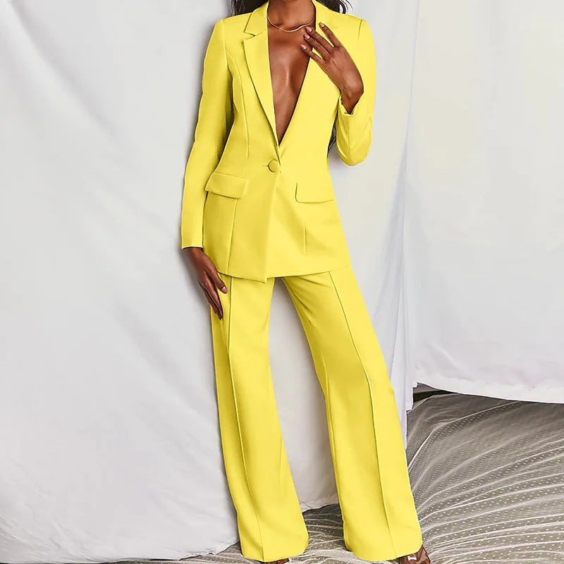 Woman modeling a yellow minimalist elegant long sleeve blazer and matching trousers suit set.
