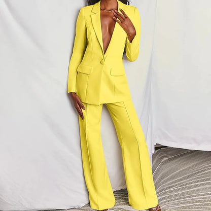 Woman modeling a yellow minimalist elegant long sleeve blazer and matching trousers suit set.
