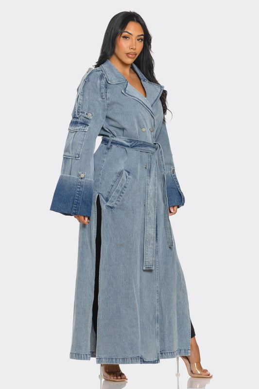 Side profile of street luxe denim trench coat showing belted waist and slit