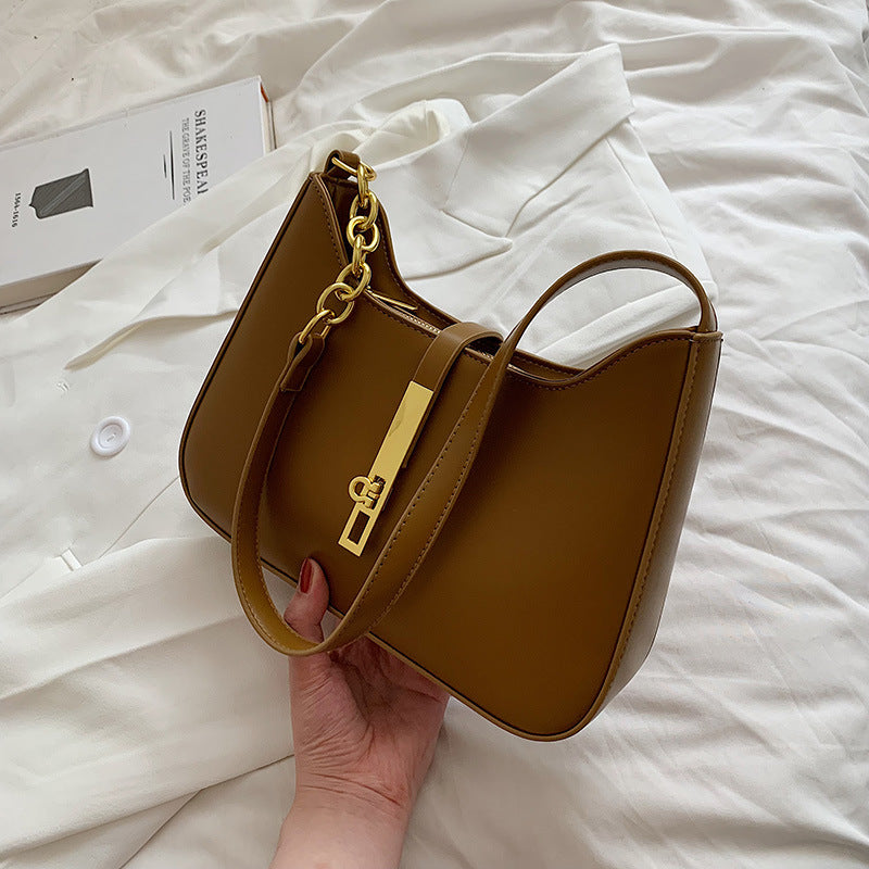 Brown minimalist shoulder bag with gold chain strap detail

