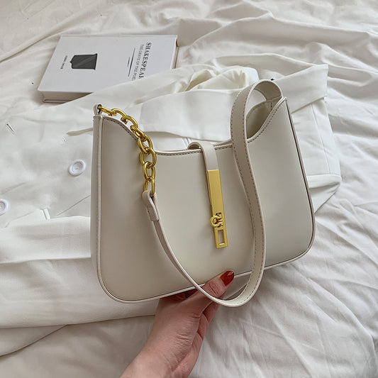 Beige minimalist shoulder bag with gold chain strap detail

