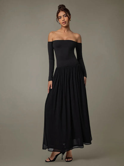 Model wearing off-shoulder long sleeve maxi dress front view in soft neutral tone background 