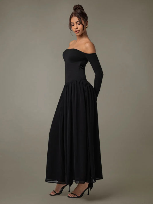 Side profile of flowing off-shoulder maxi dress with long sleeves on model