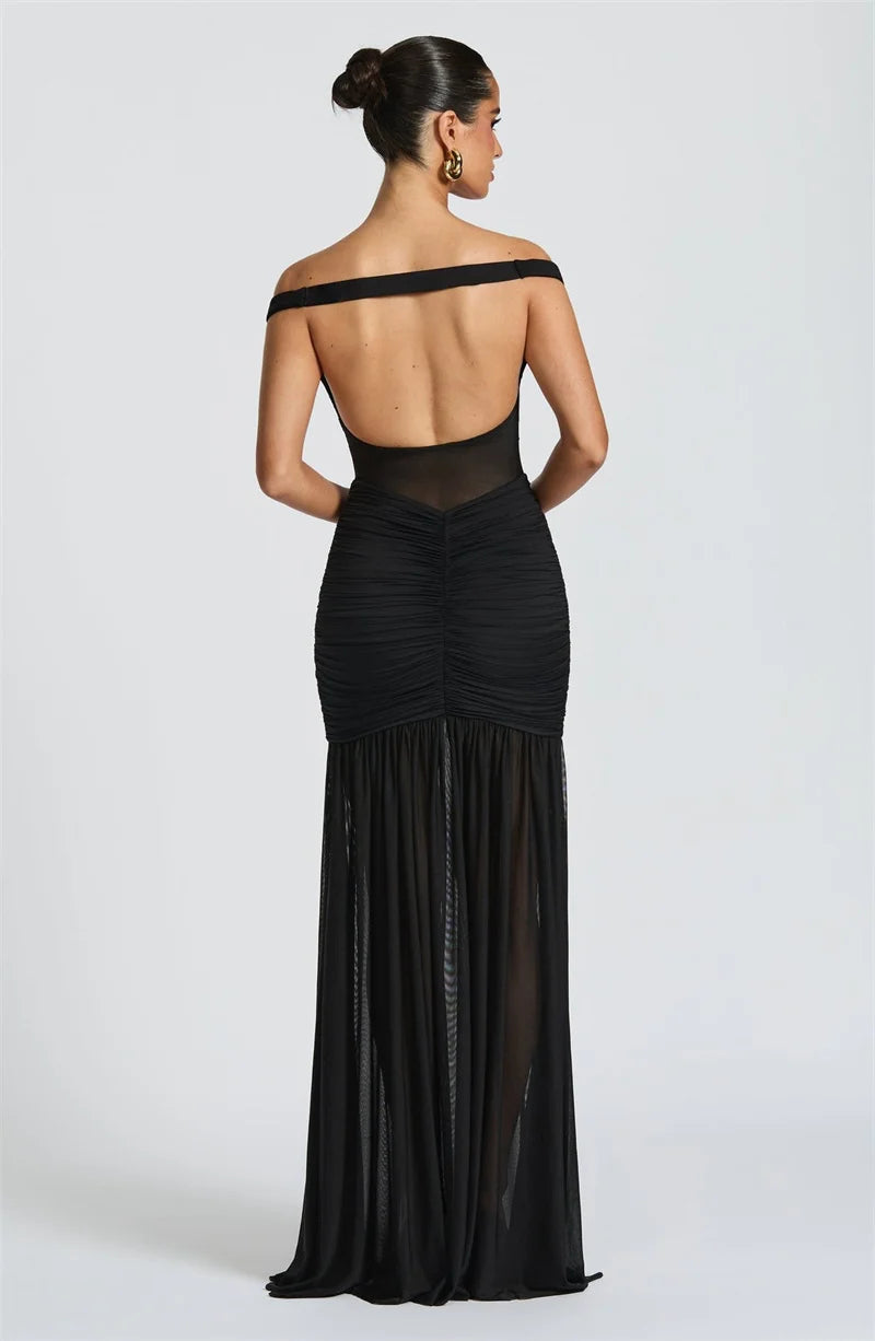 Model showcasing open back of the formal black maxi dress
