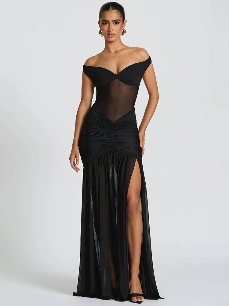 Woman in a black off shoulder backless split maxi dress front view
