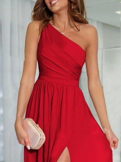 Close up of woman wearing a red one-shoulder maxi formal dress with a thigh high slit