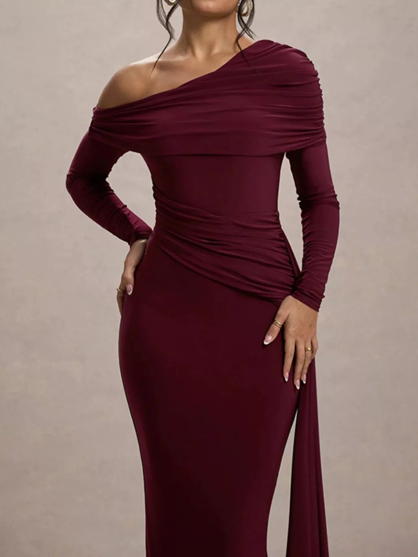 woman wearing a bodycon off shoulder long sleeve maxi dress 