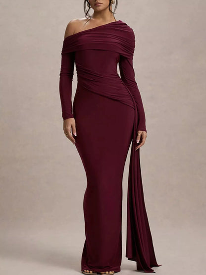 model posing in a burgundy formal one shoulder maxi dress