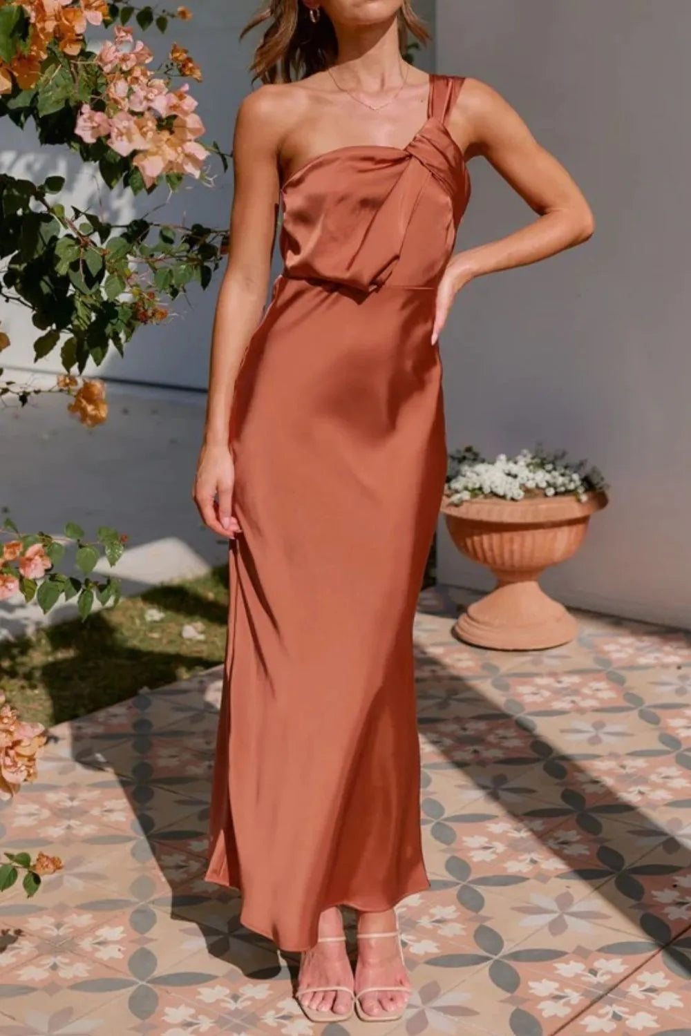 Model in sleek one-shoulder sleeveless maxi dress with sculpted fit