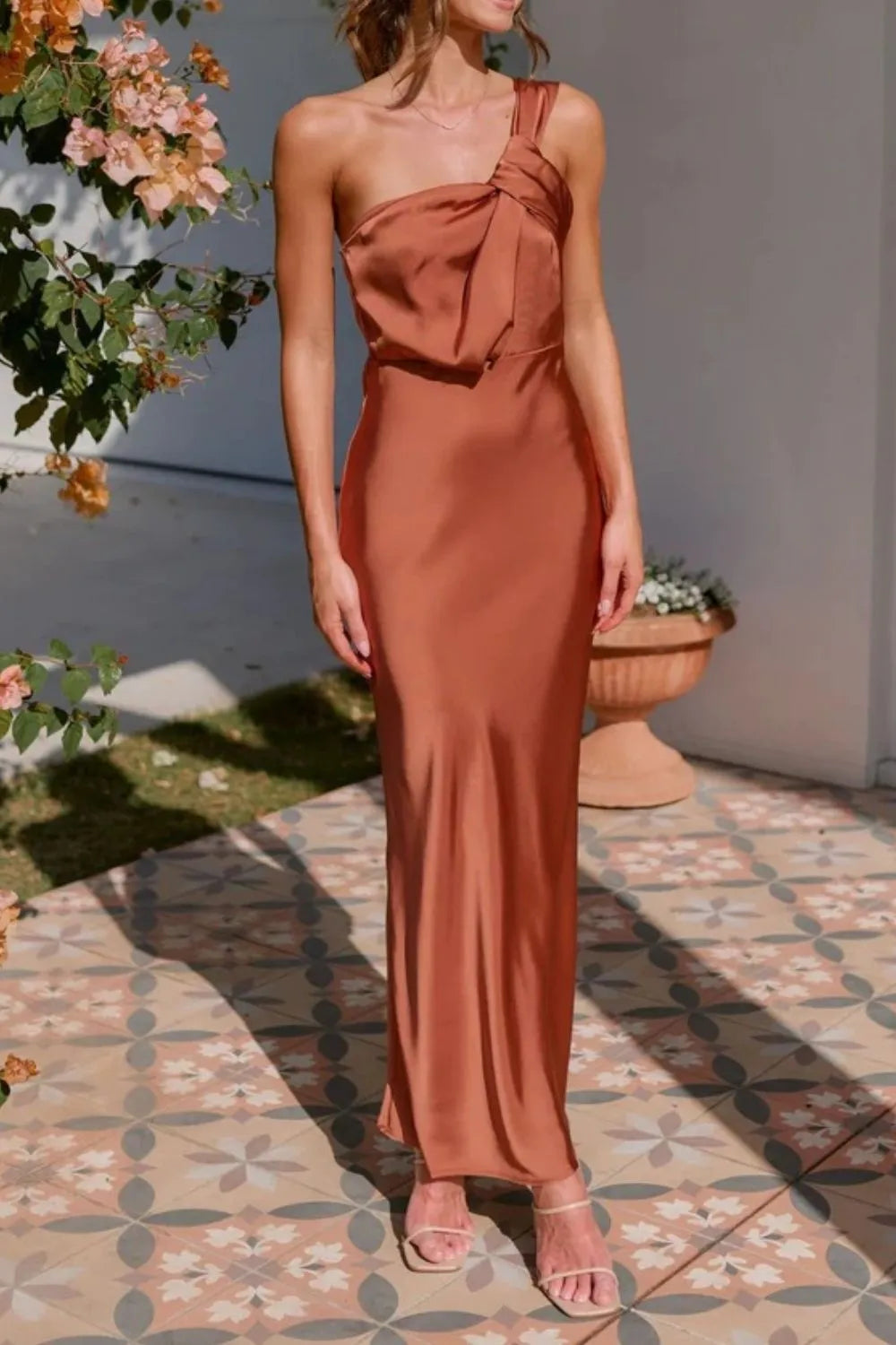 Model in sleek one-shoulder sleeveless maxi dress with sculpted fit