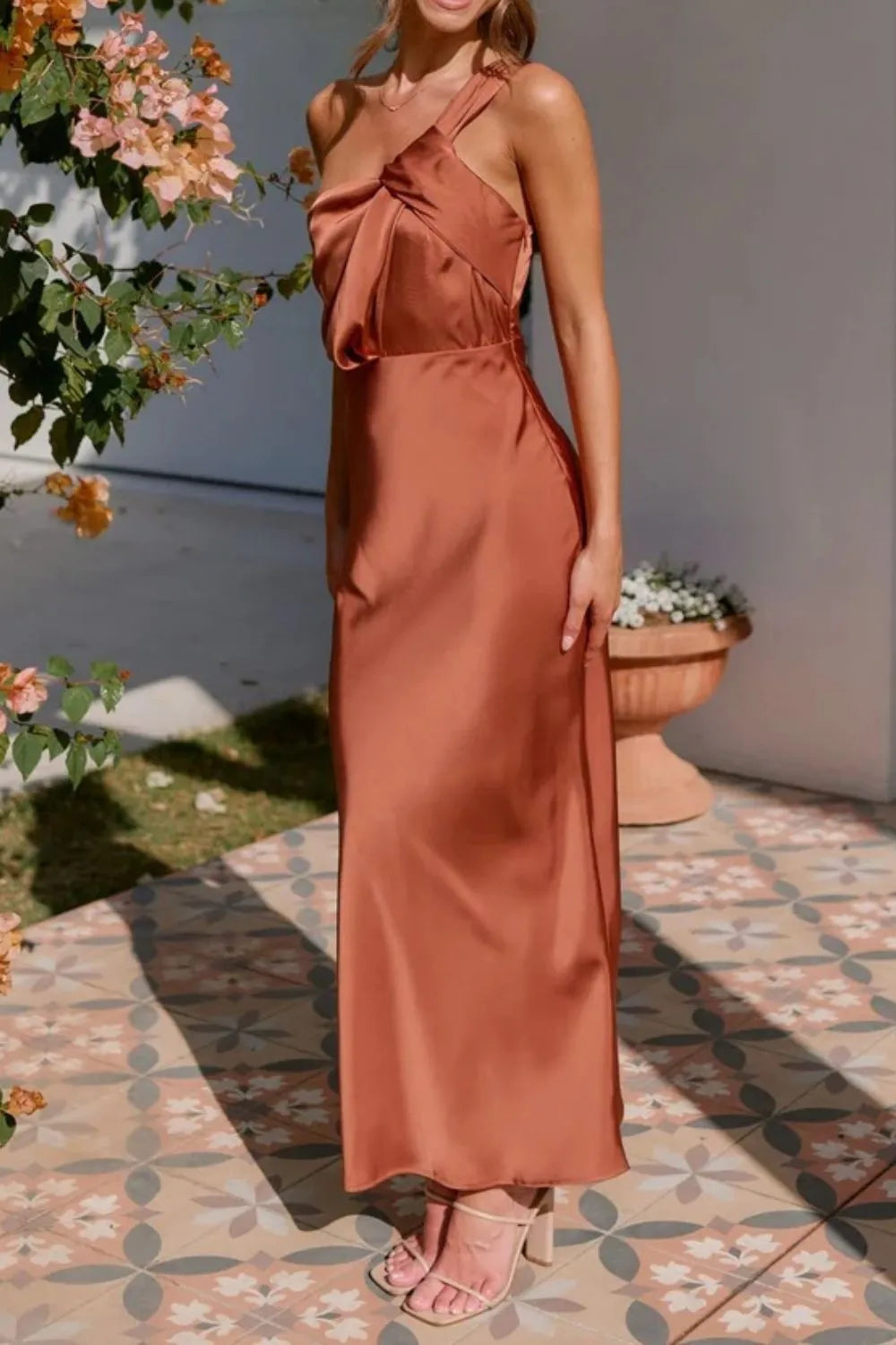 Model in sleek one-shoulder sleeveless maxi dress with sculpted fit side view