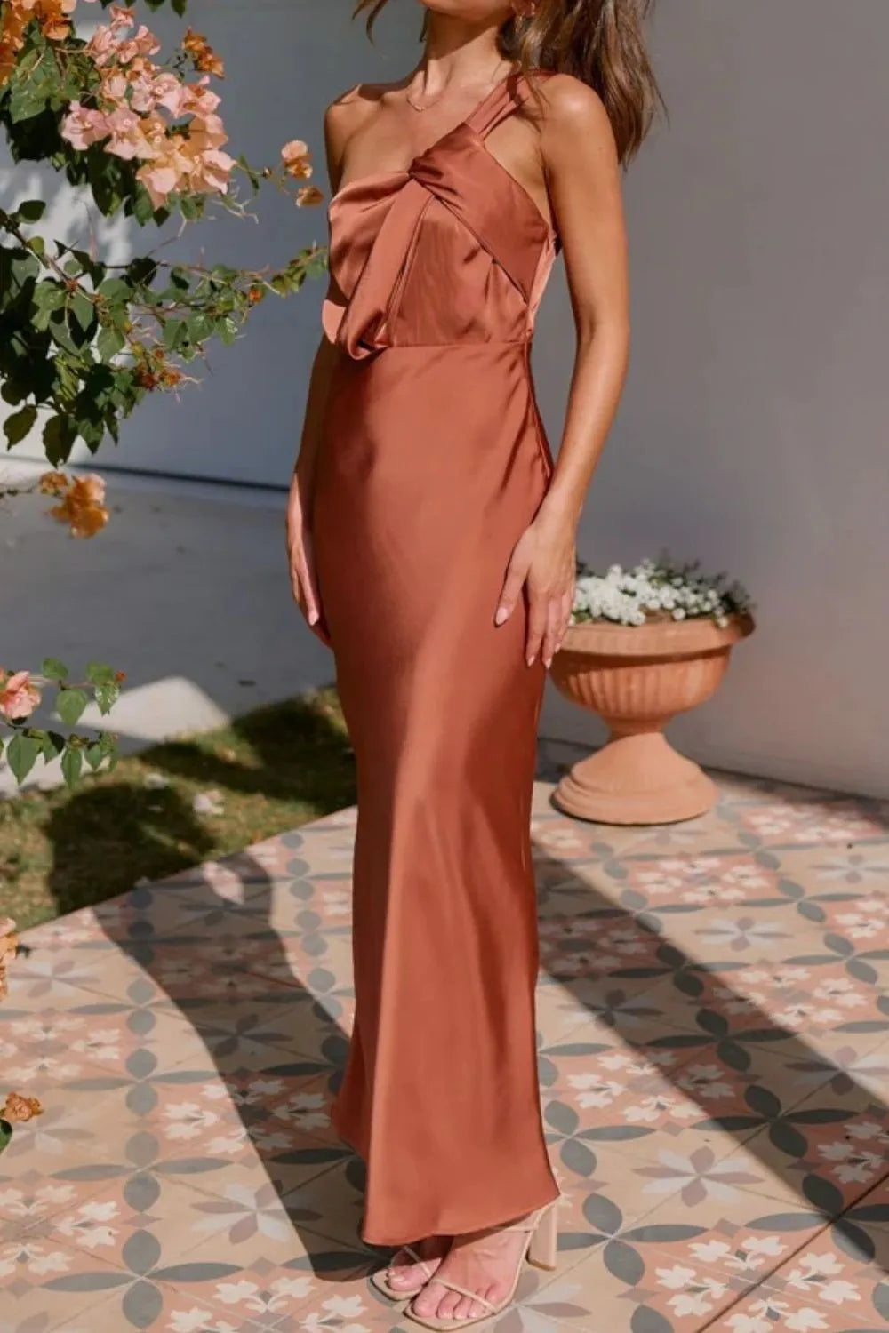 Model in sleek one-shoulder sleeveless maxi dress with sculpted fit side view