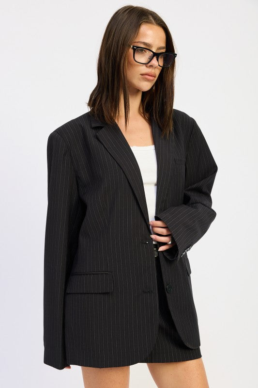 woman wearing a chic black longline striped blazer for women office and street style