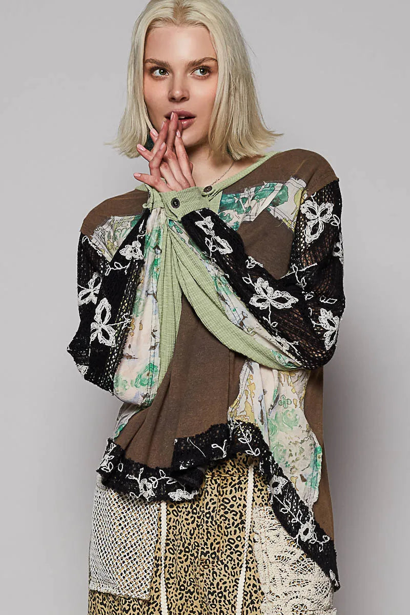Model posing in floral patchwork blouse with crochet lace long sleeves 