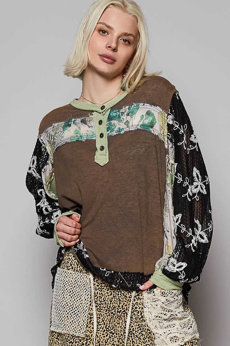Model wearing floral patchwork blouse with crochet lace long sleeves front view