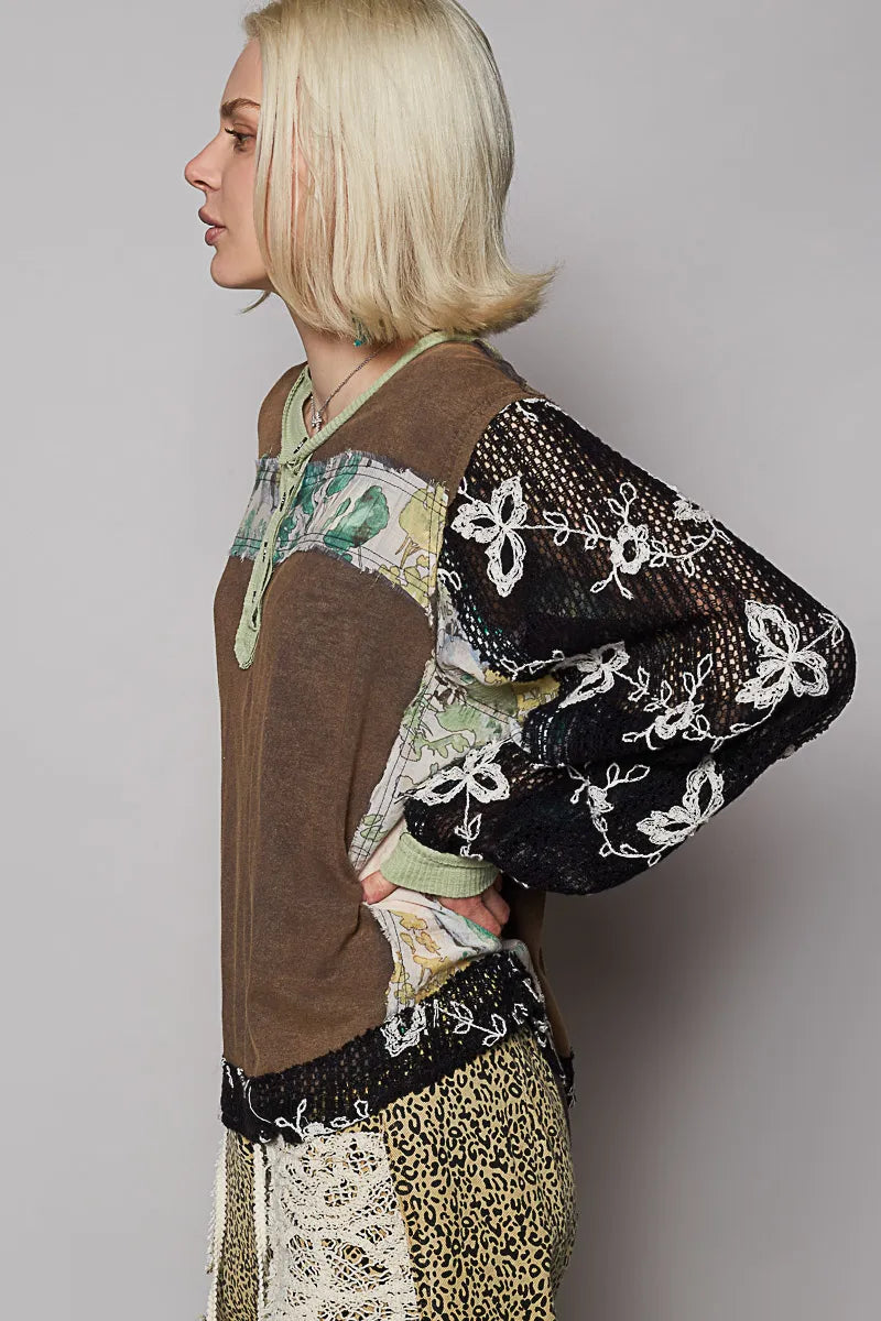 Model wearing floral patchwork blouse with crochet lace long sleeves side view