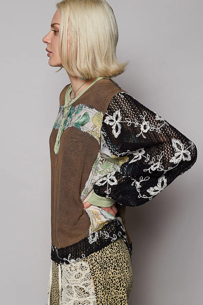Model wearing floral patchwork blouse with crochet lace long sleeves side view