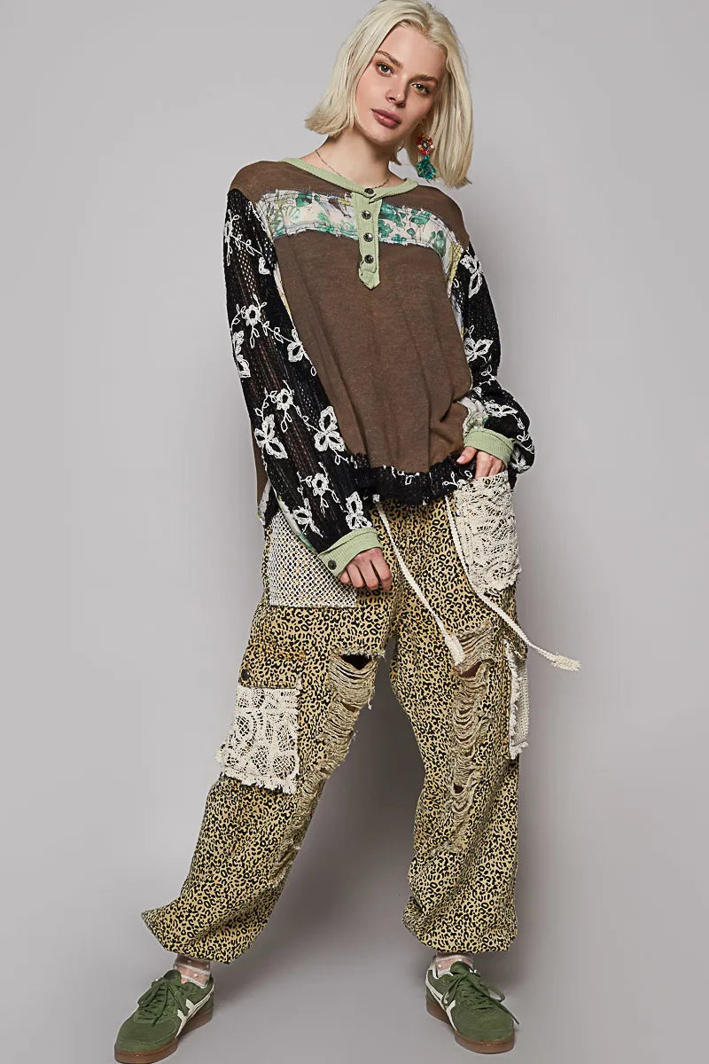 Model posing floral patchwork blouse with crochet lace long sleeves front