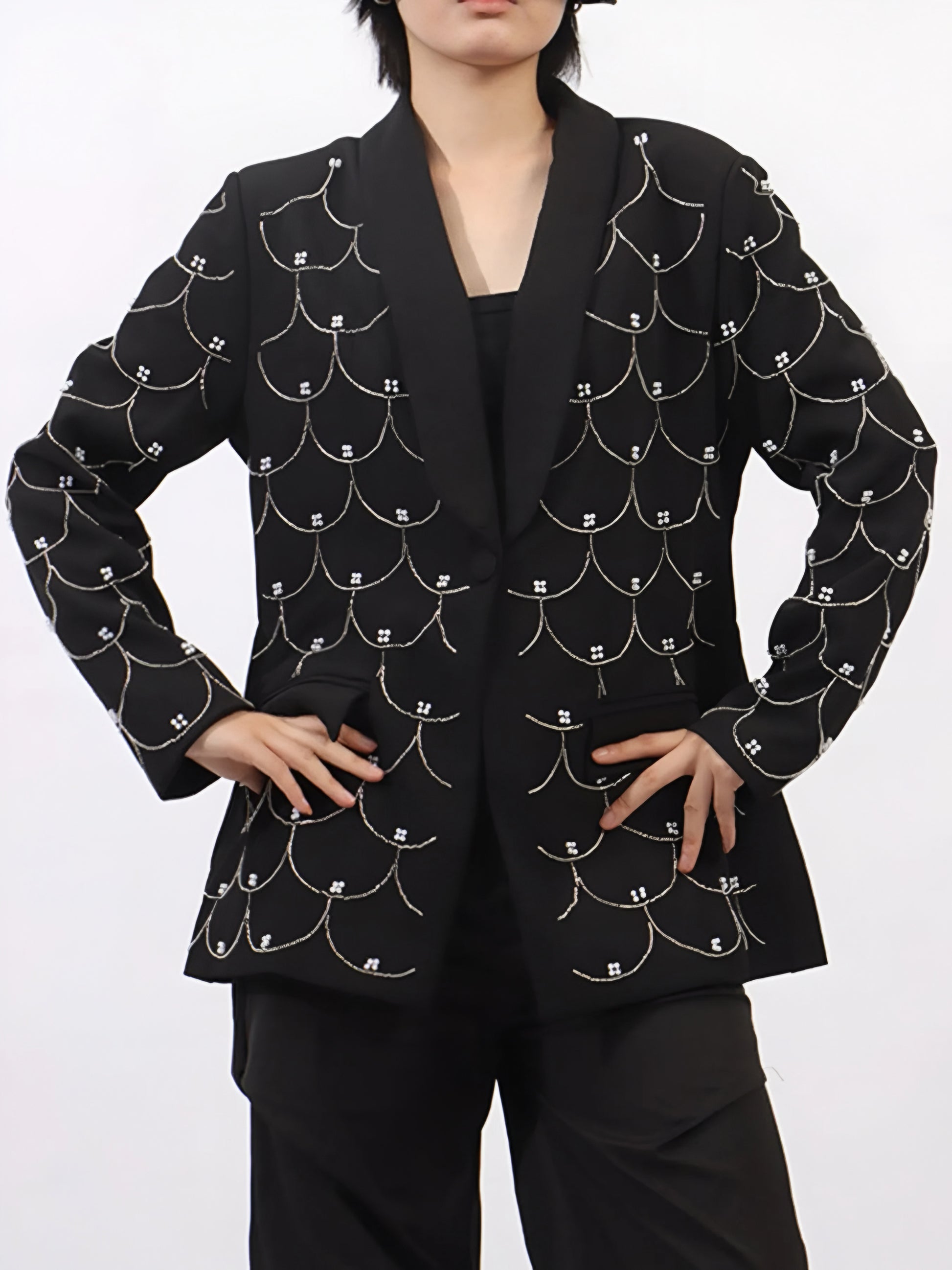 woman wearing a black couture designer inspired pearl-embellished statement blazer