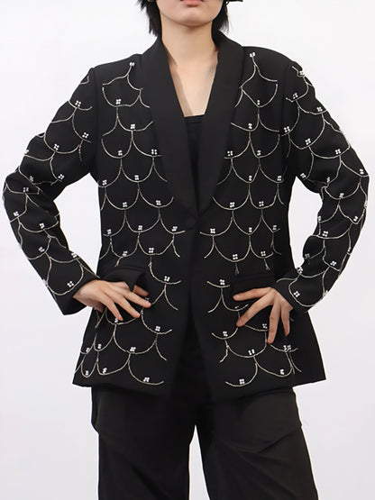 woman wearing a black couture designer inspired pearl-embellished statement blazer
