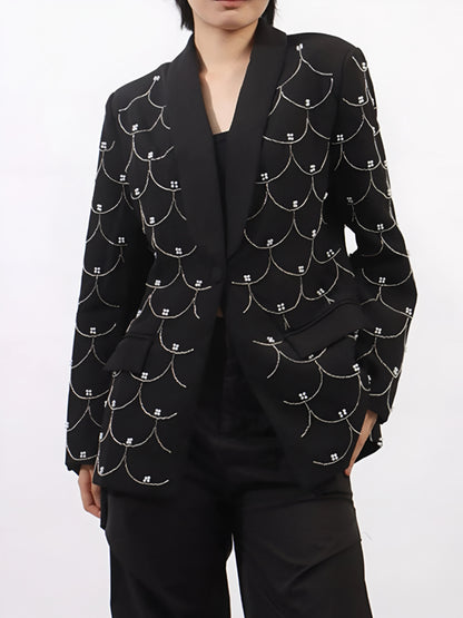 Woman posing in a black luxury pearl-detail long sleeve blazer for women on a white background