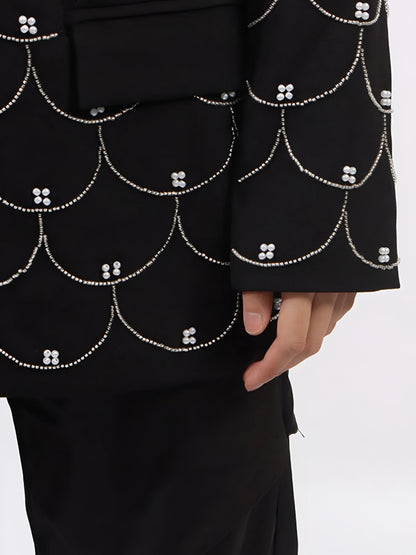 Close up of women’s tailored blazer with all over pearl embellishments