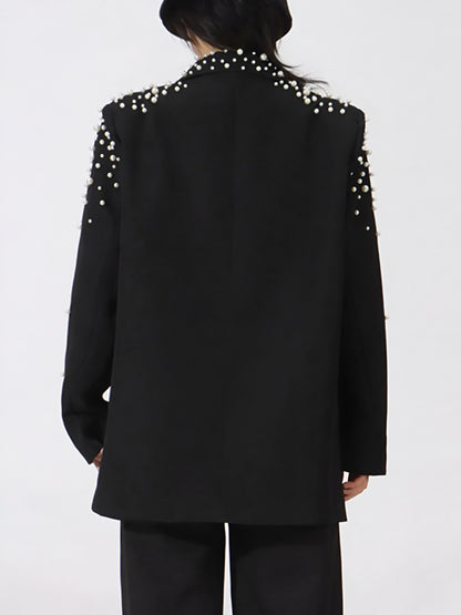 back of black high end fashion pearl embellished blazer on a white background