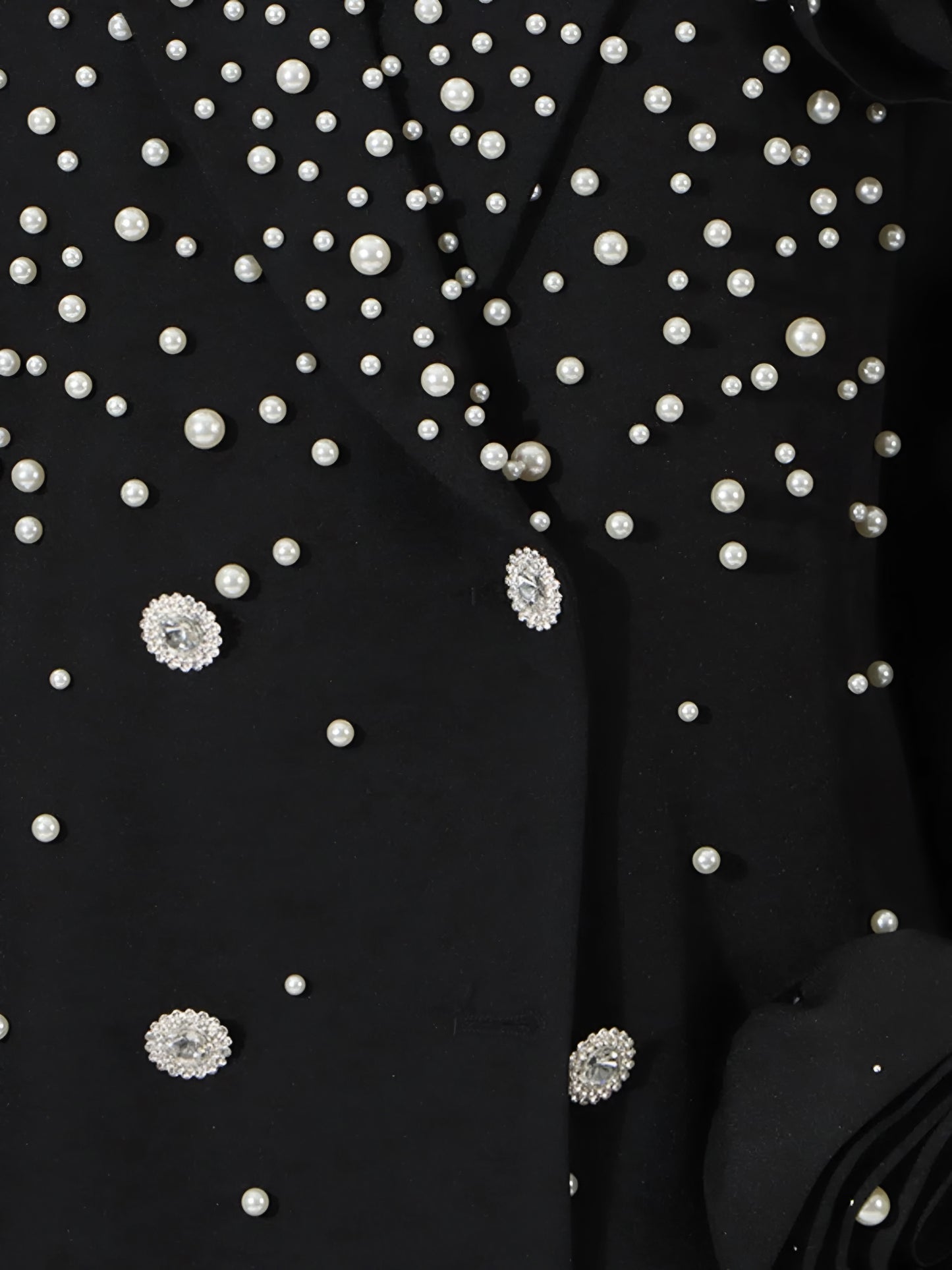 Close up of Luxury pearl embellished black blazer for women