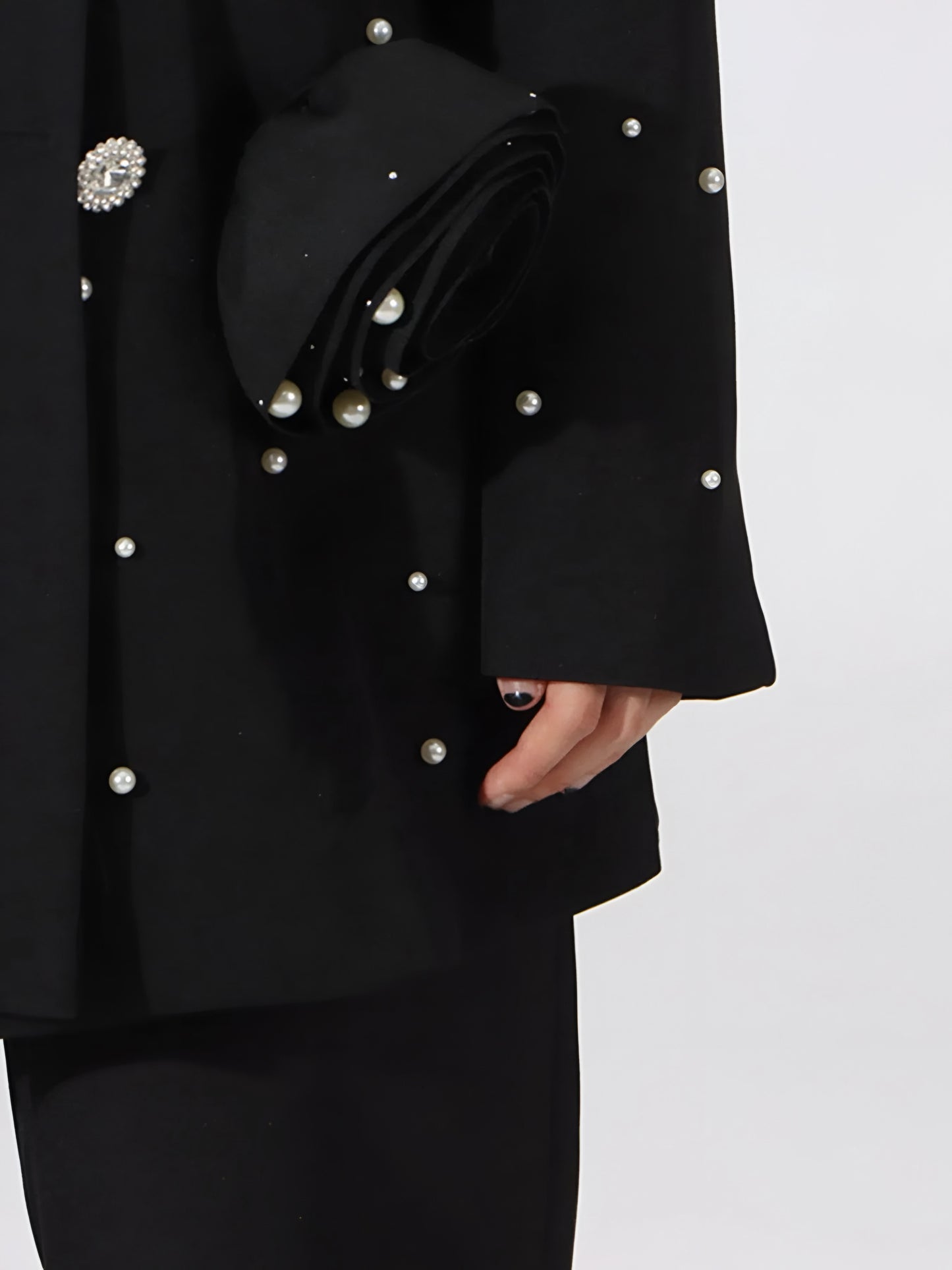 Close up of sleeve of luxury pearl embellished black blazer for women