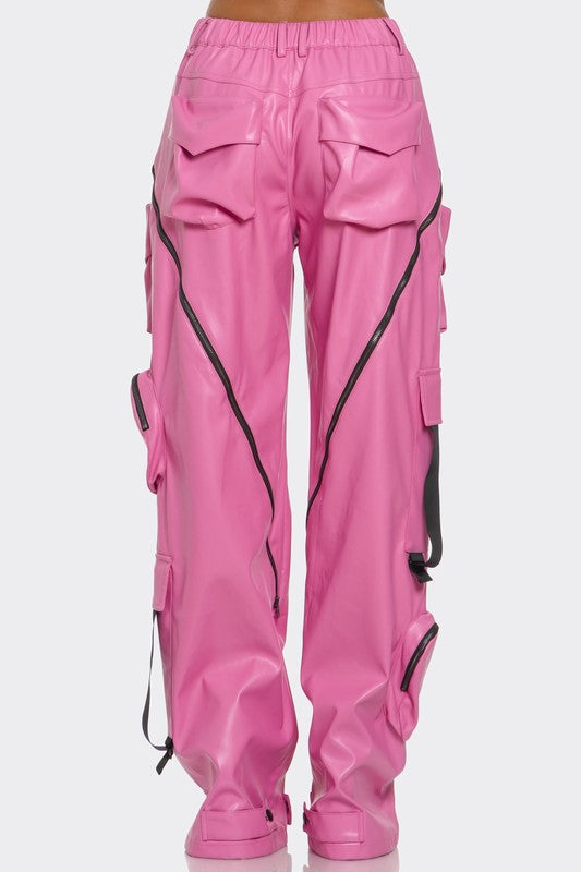 back view of pink leather high waisted cargo wide leg pants for women high fashion with oversized pockets, zipper details and adjustable straps