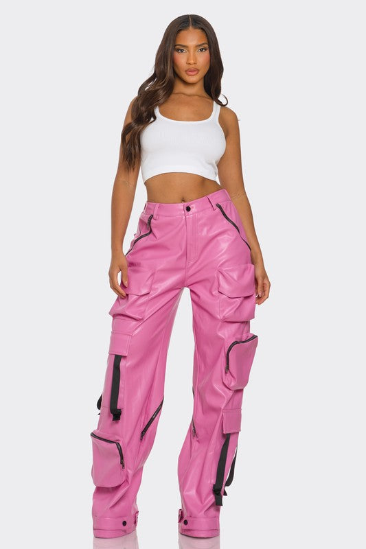 front view of pink leather high waisted cargo wide leg utility pants for women high fashion with oversized pockets, zipper details and adjustable straps