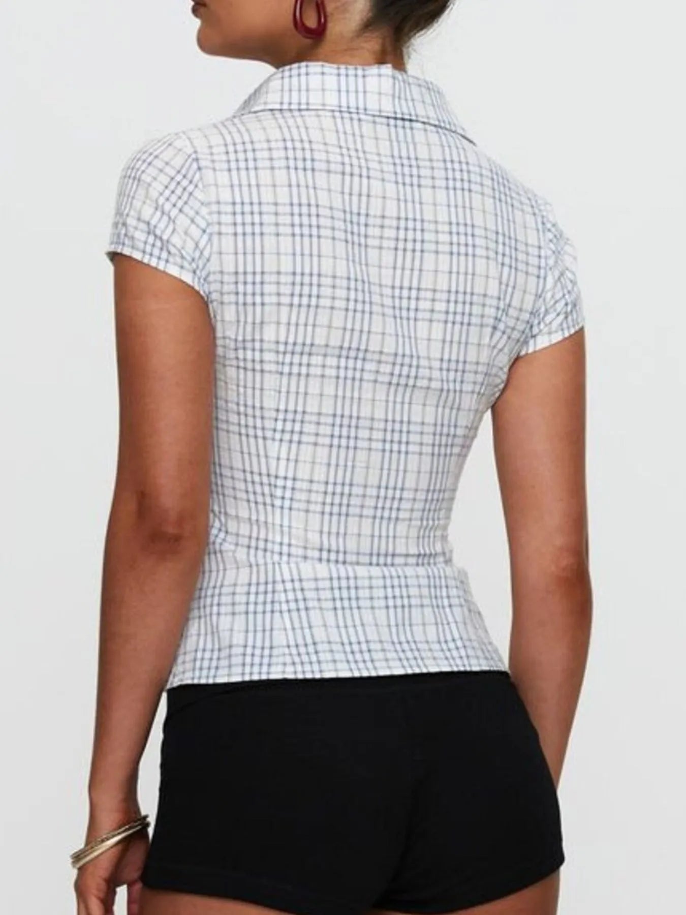 Model in plaid blue short sleeve button-up shirt with relaxed fitted look back view