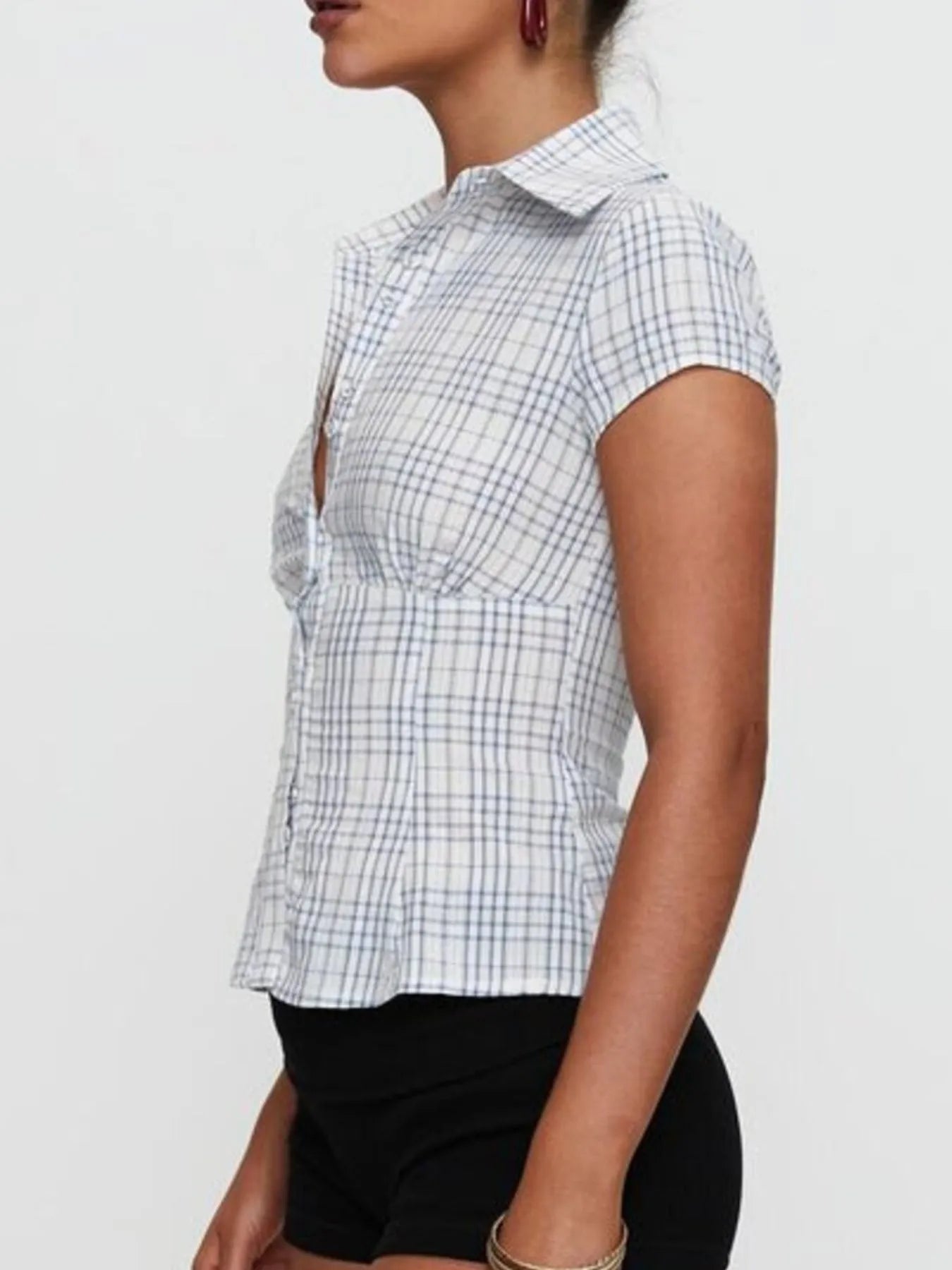 Model in plaid blue short sleeve button-up shirt with relaxed fitted look side view