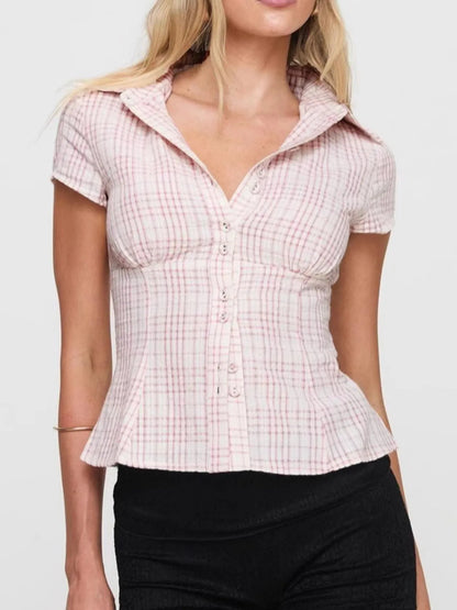 Model in plaid pink short sleeve button-up shirt with relaxed fitted look front view