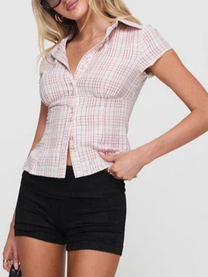 Model in plaid pink short sleeve button-up shirt with relaxed fitted look front view with black shorts