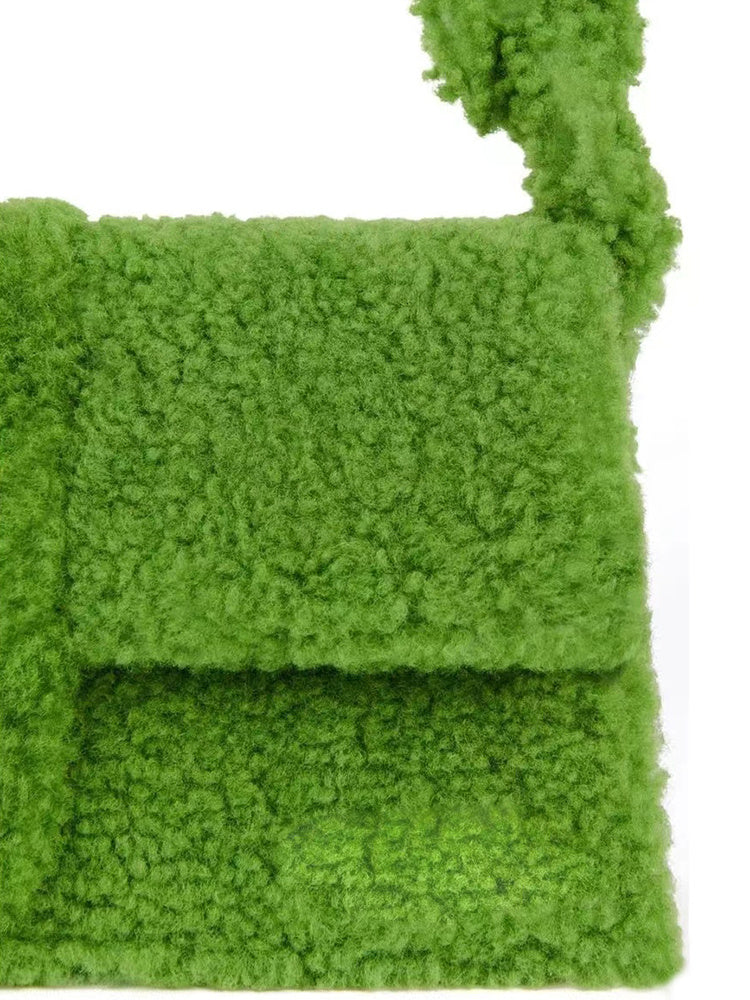 Bold green cozy-textured purse with braided top handle close up