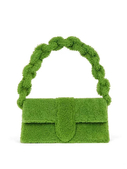 Bright green plush handbag with braided sherpa strap up on white background