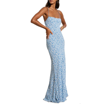 Model wearing a printed blue floral dress with a backless and lace-up feature front view