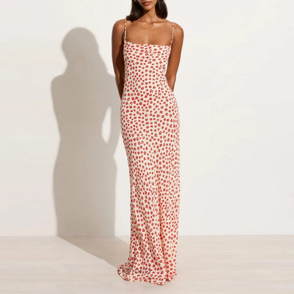 Model wearing a printed red floral dress with a backless and lace-up feature front view